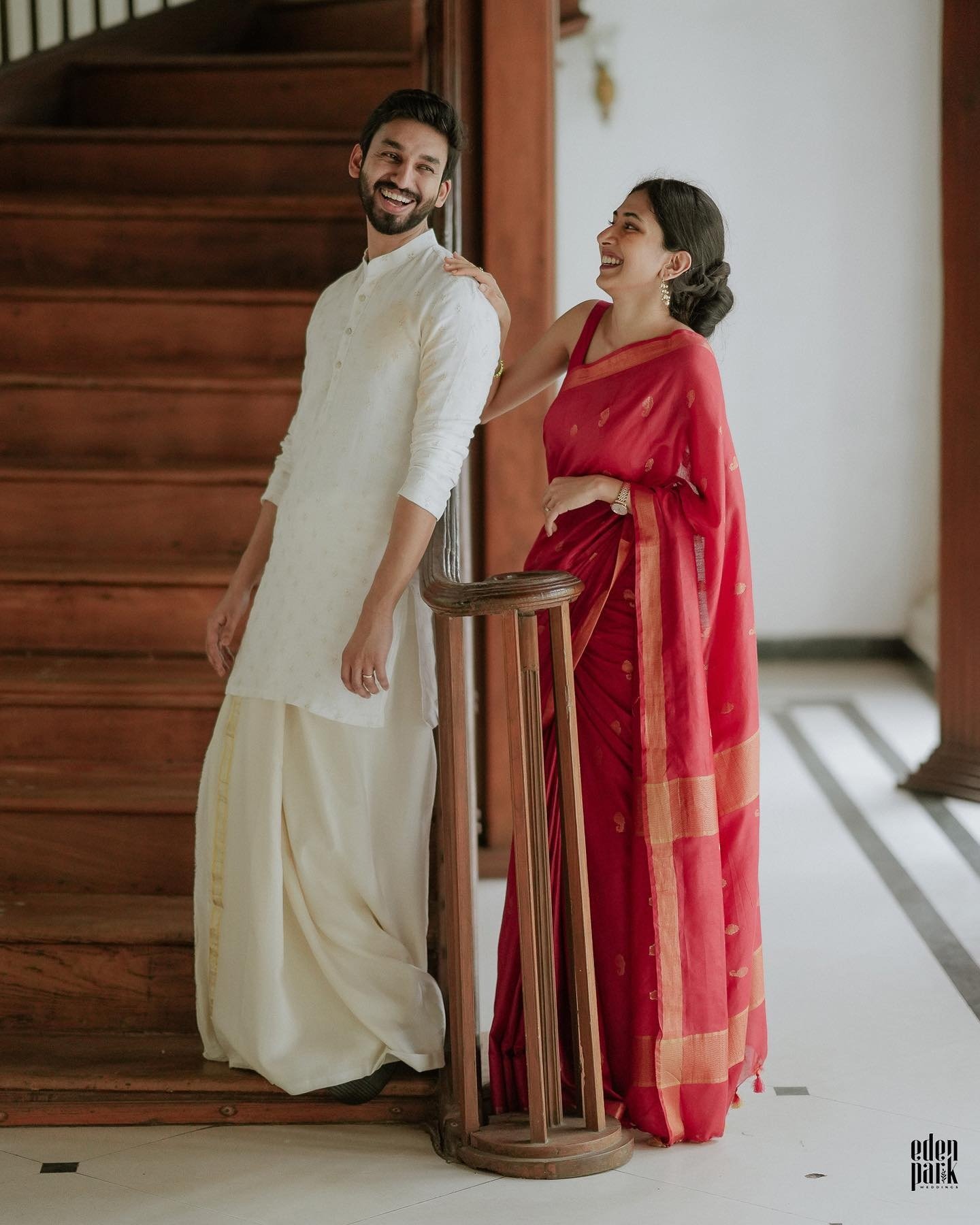 A couple laughing together on a staircase